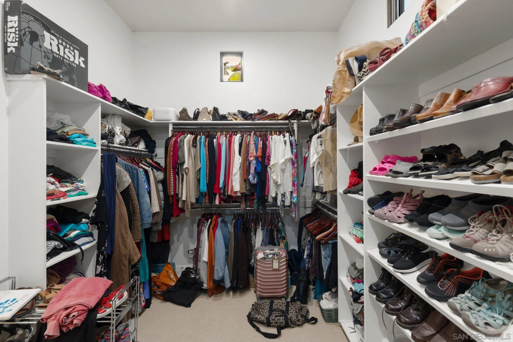 29746 Nella Lane Bonsall, CA 92084 - Photo 26 of 39 a view of walk in closet with clothes and shoes