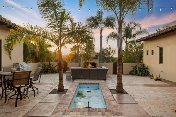 a view of a patio with table and chairs and potted plants