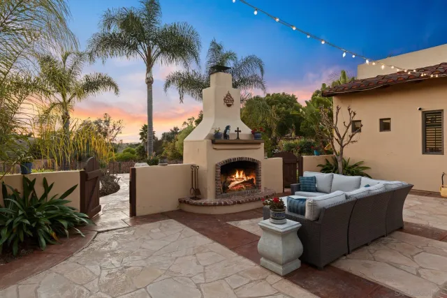 a view of a patio with couches and a fire pit