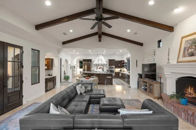 a living room with fireplace furniture and a flat screen tv