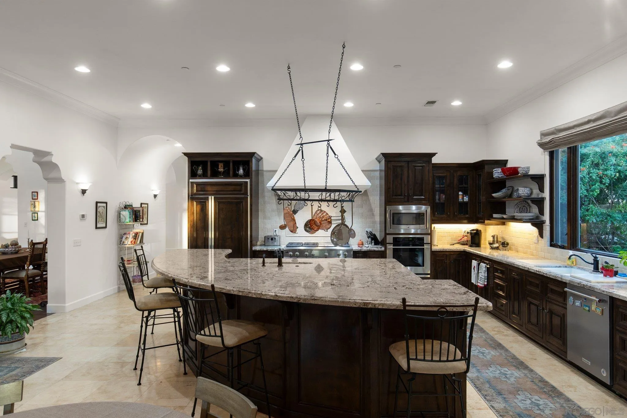 29746 Nella Lane Bonsall, CA 92084 - Photo 9 of 39 a kitchen with stainless steel appliances granite countertop a stove a sink a refrigerator white cabinets and chairs