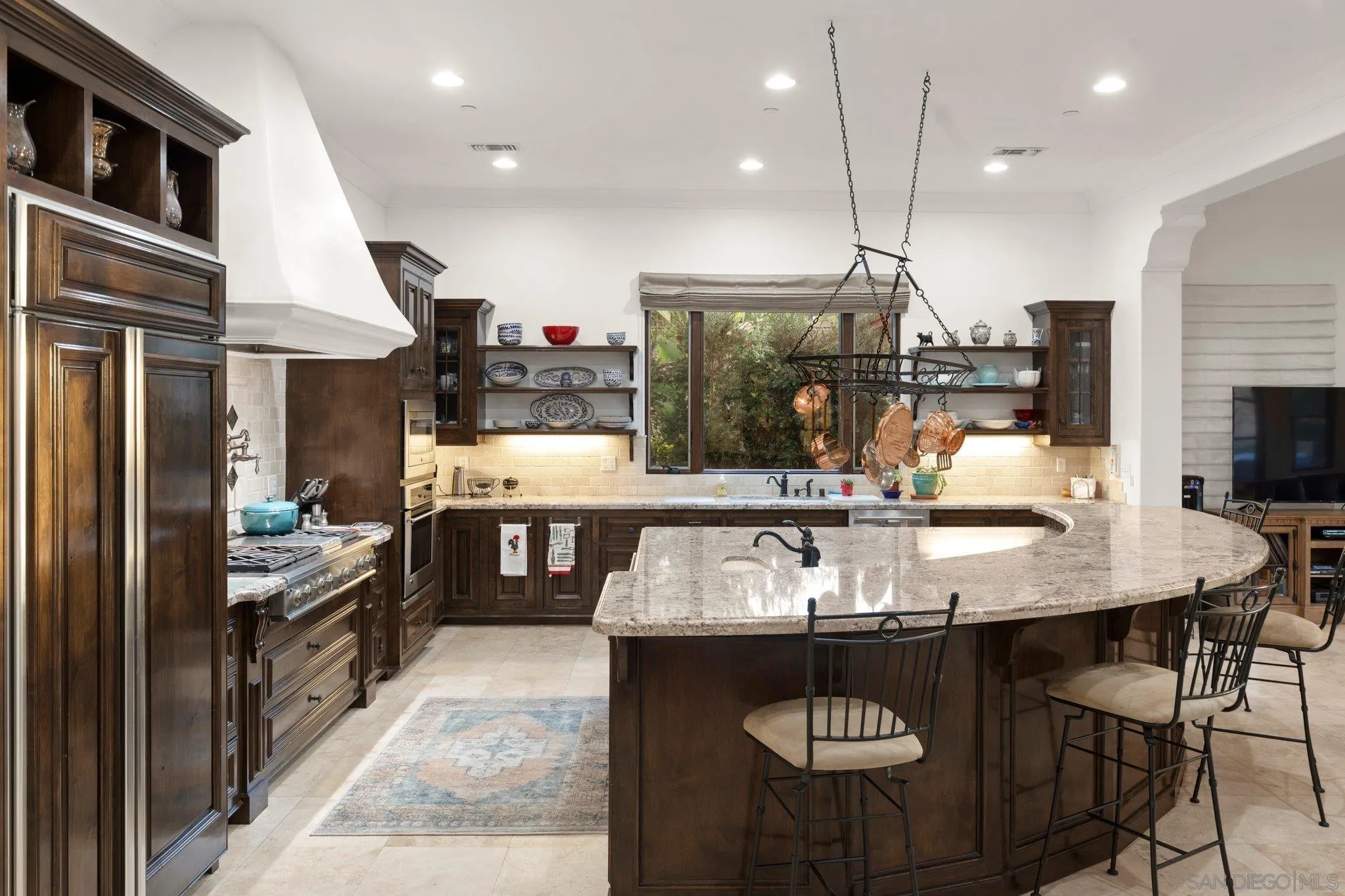 29746 Nella Lane Bonsall, CA 92084 - Photo 10 of 39 a kitchen with stainless steel appliances granite countertop a stove a refrigerator and a kitchen island