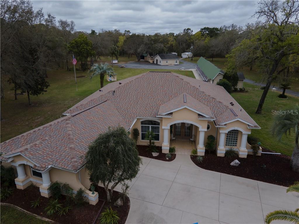 an aerial view of a house with a yard