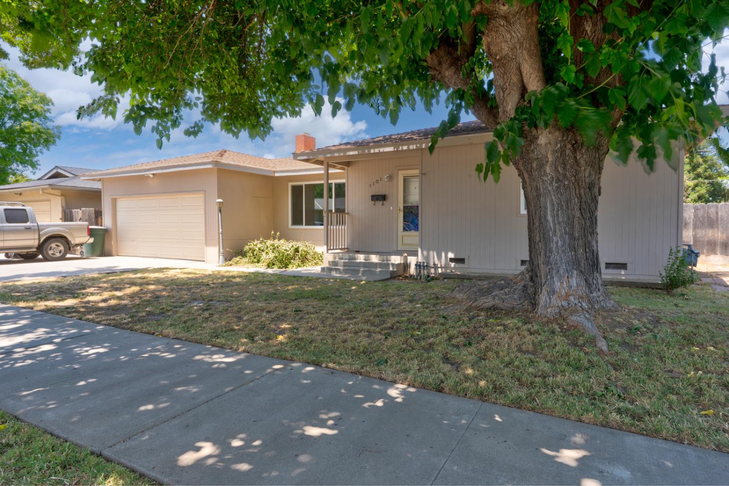 1101 Kensington Drive Merced, CA 95340 - Photo 1 of 1 a front view of a house with garden