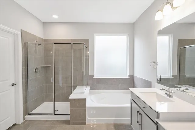a bathroom with a shower sink and mirror