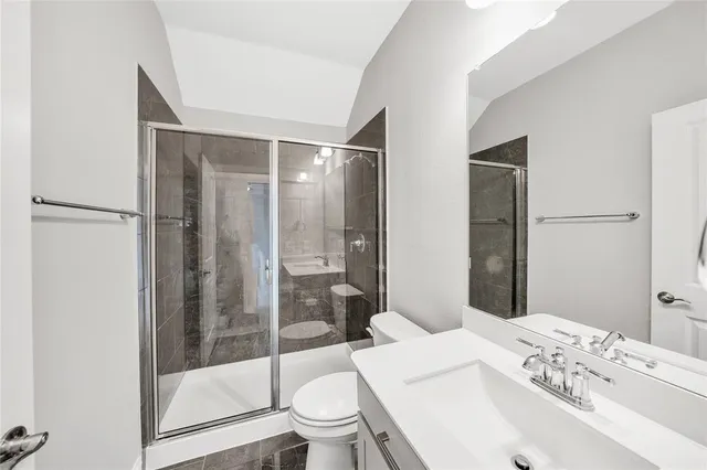 a bathroom with a sink toilet and shower