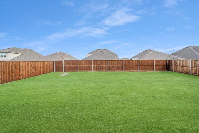 a view of a large garden with wooden fence