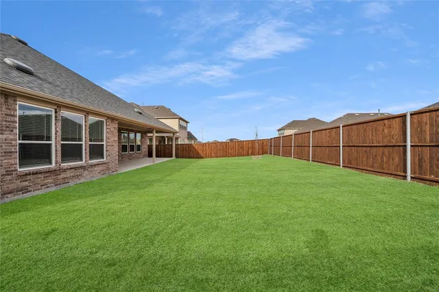 a view of an house with backyard space and balcony