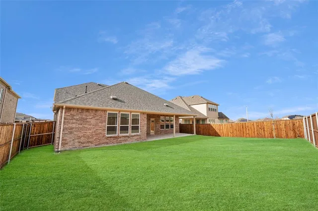 a view of a house with a yard and sitting area
