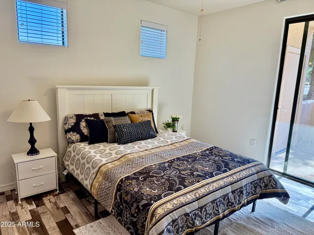 a bed sitting in a bedroom next to a lamp