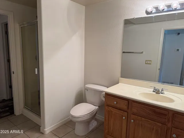 a bathroom with a black and white checkered floor