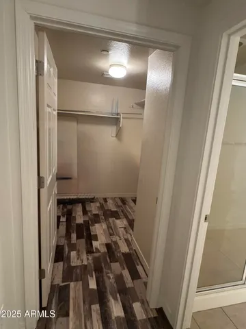 a utility room with a washer dryer and white cabinets