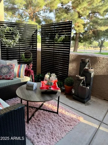 a view of a patio with table and chairs and potted plants