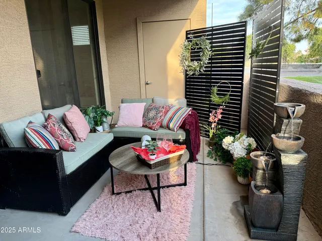 a living room with furniture and flowers