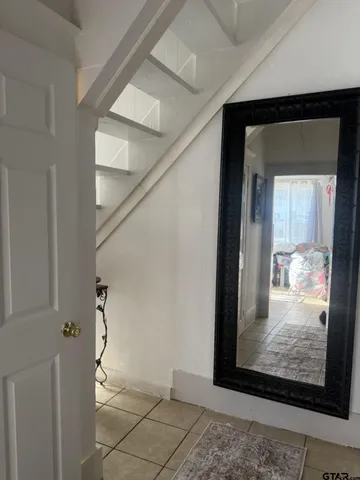 a living room with a bed and a ceiling fan