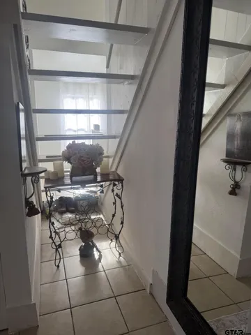 a bedroom with a bed a couch and dresser