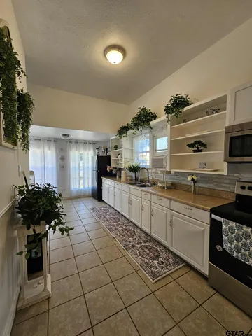 a living room with furniture and flowers