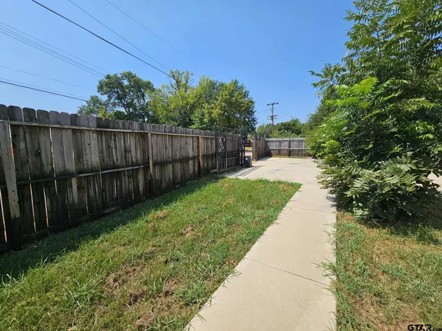 a view of a park with large trees