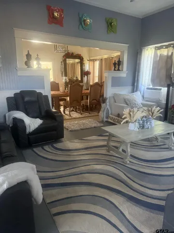 a living room with furniture and large windows