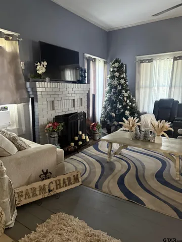 a living room with furniture a flat screen tv and a fireplace