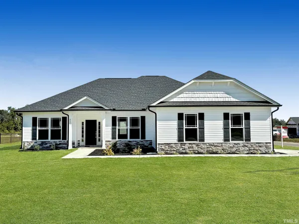 a front view of house with yard and outdoor seating