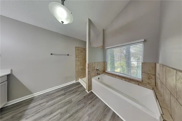 a spacious bathroom with a tub and shower