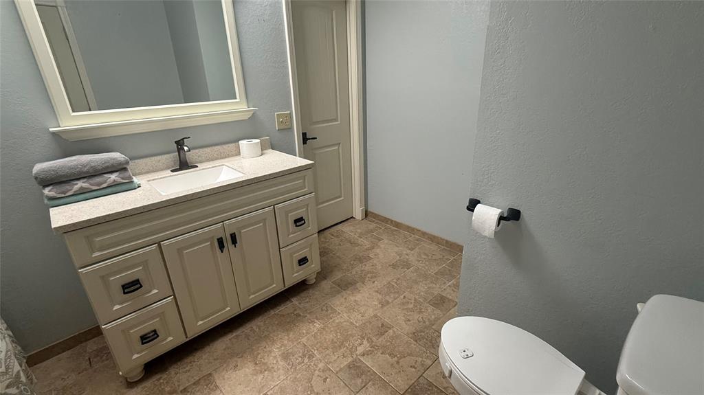 1356 Kerry Lane Azle, TX 76020 - Photo 17 of 27 Bathroom featuring a contemporary vanity with an integrated sink, light-toned countertop, and dark-finished faucet