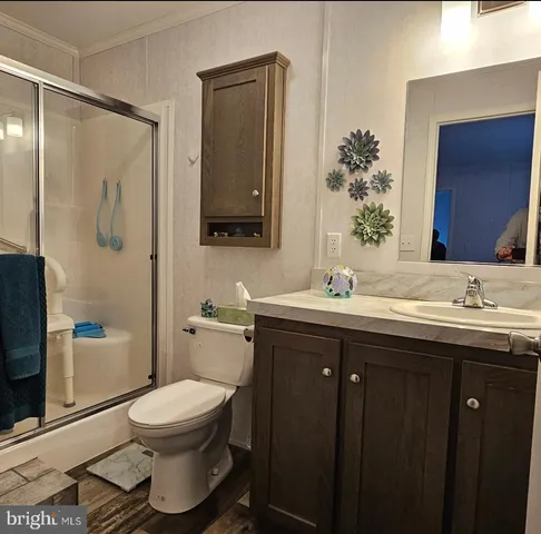 a bathroom with a double vanity sink toilet and shower
