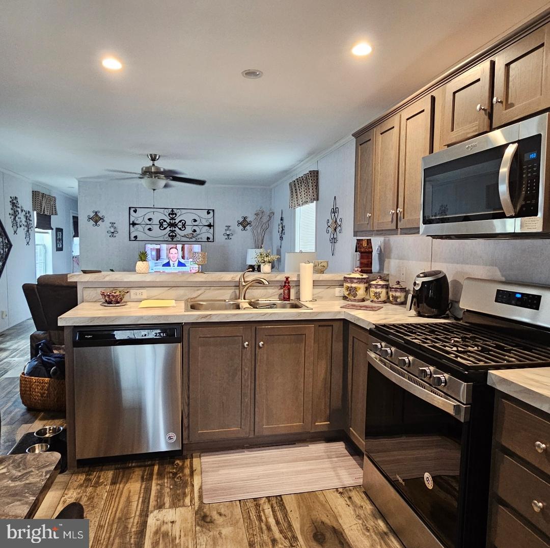 2110 Mays Landing Road, Unit 14 Millville, NJ 08332 - Photo 4 of 12 a kitchen with a sink appliances and cabinets