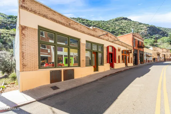 a view of a building with a couple of cars parked in front of it