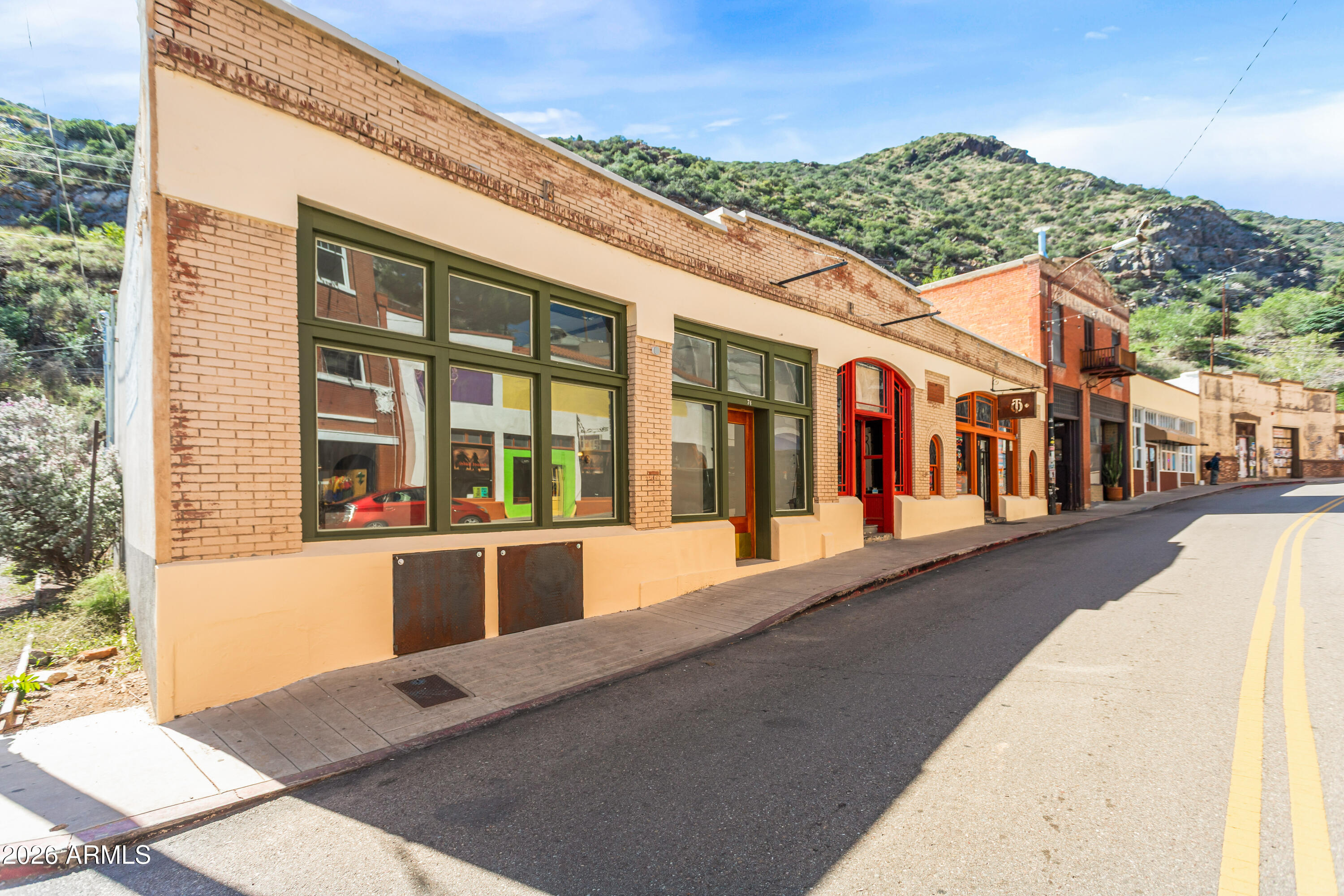 72-78 Main Street Bisbee, AZ 85603 - Photo 1 of 46 a view of a building with a couple of cars parked in front of it