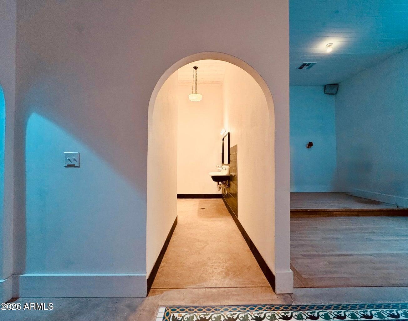 72-78 Main Street Bisbee, AZ 85603 - Photo 15 of 46 a view of a hallway with wooden floor and a bathroom
