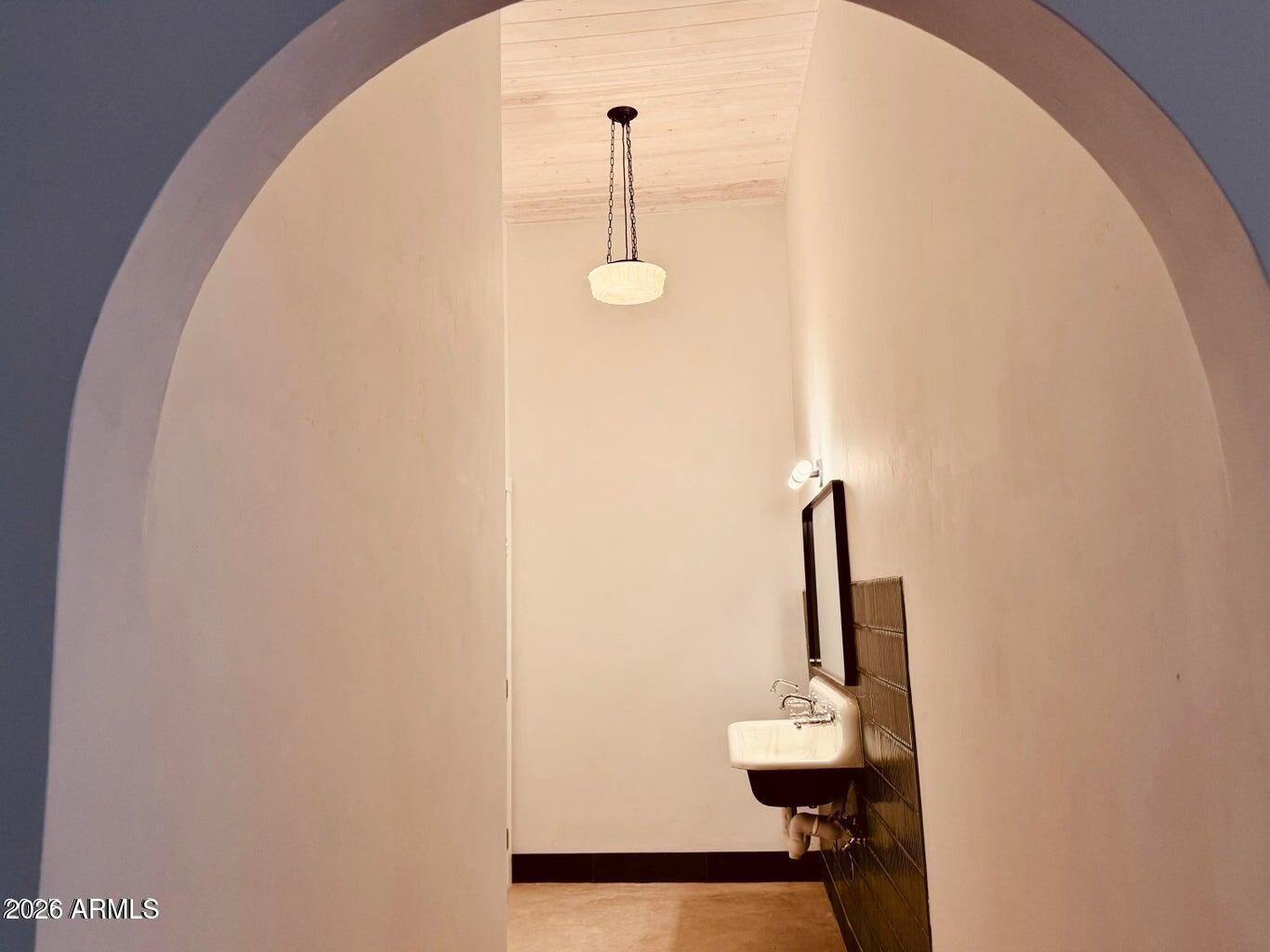72-78 Main Street Bisbee, AZ 85603 - Photo 16 of 46 a view of a hallway with wooden floor and windows