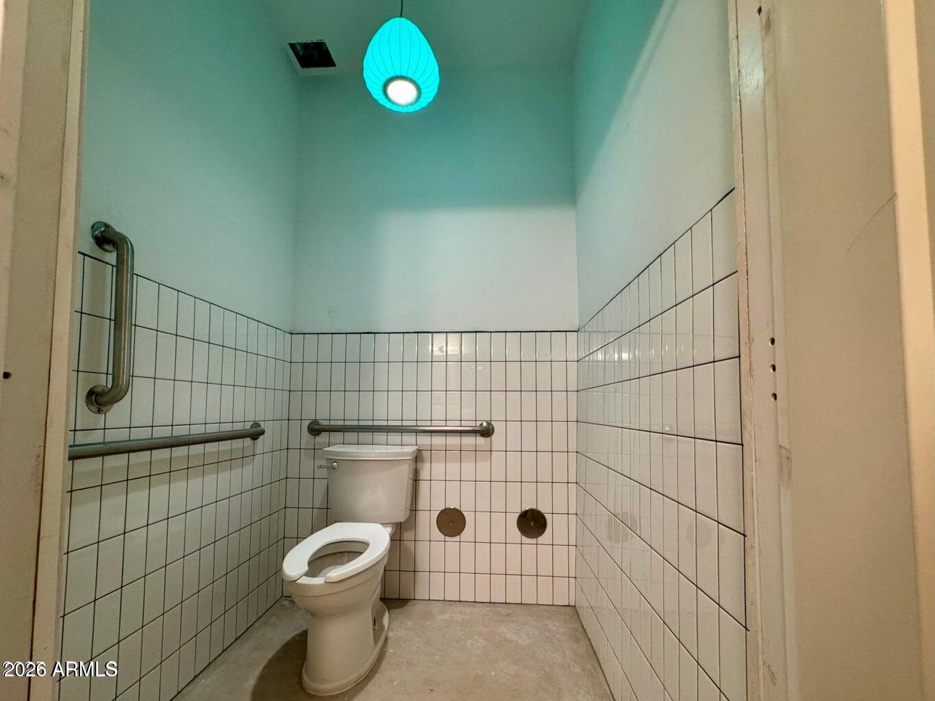 72-78 Main Street Bisbee, AZ 85603 - Photo 18 of 46 a bathroom with a toilet and a shower