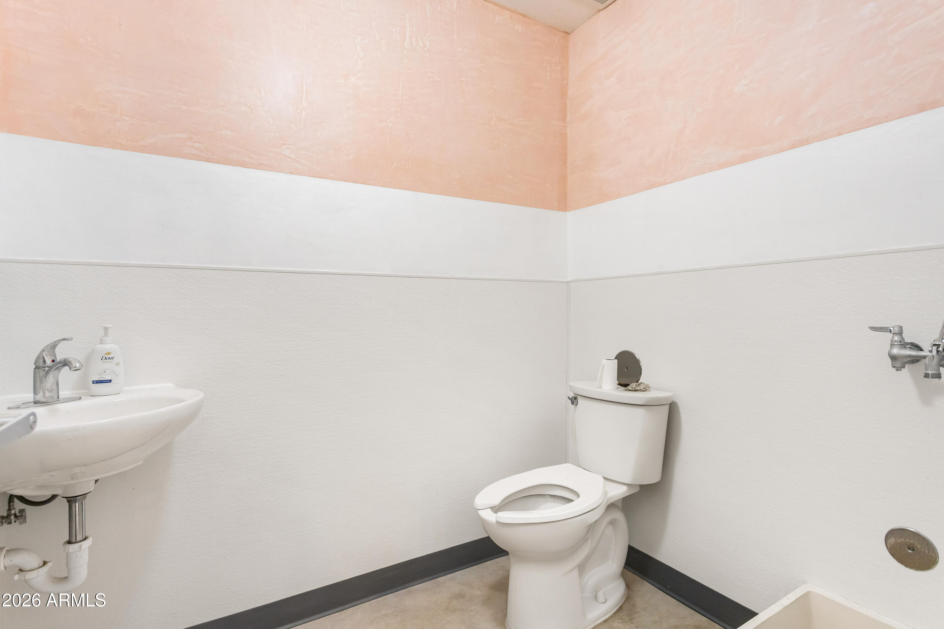 72-78 Main Street Bisbee, AZ 85603 - Photo 21 of 46 a bathroom with a sink toilet and a mirror