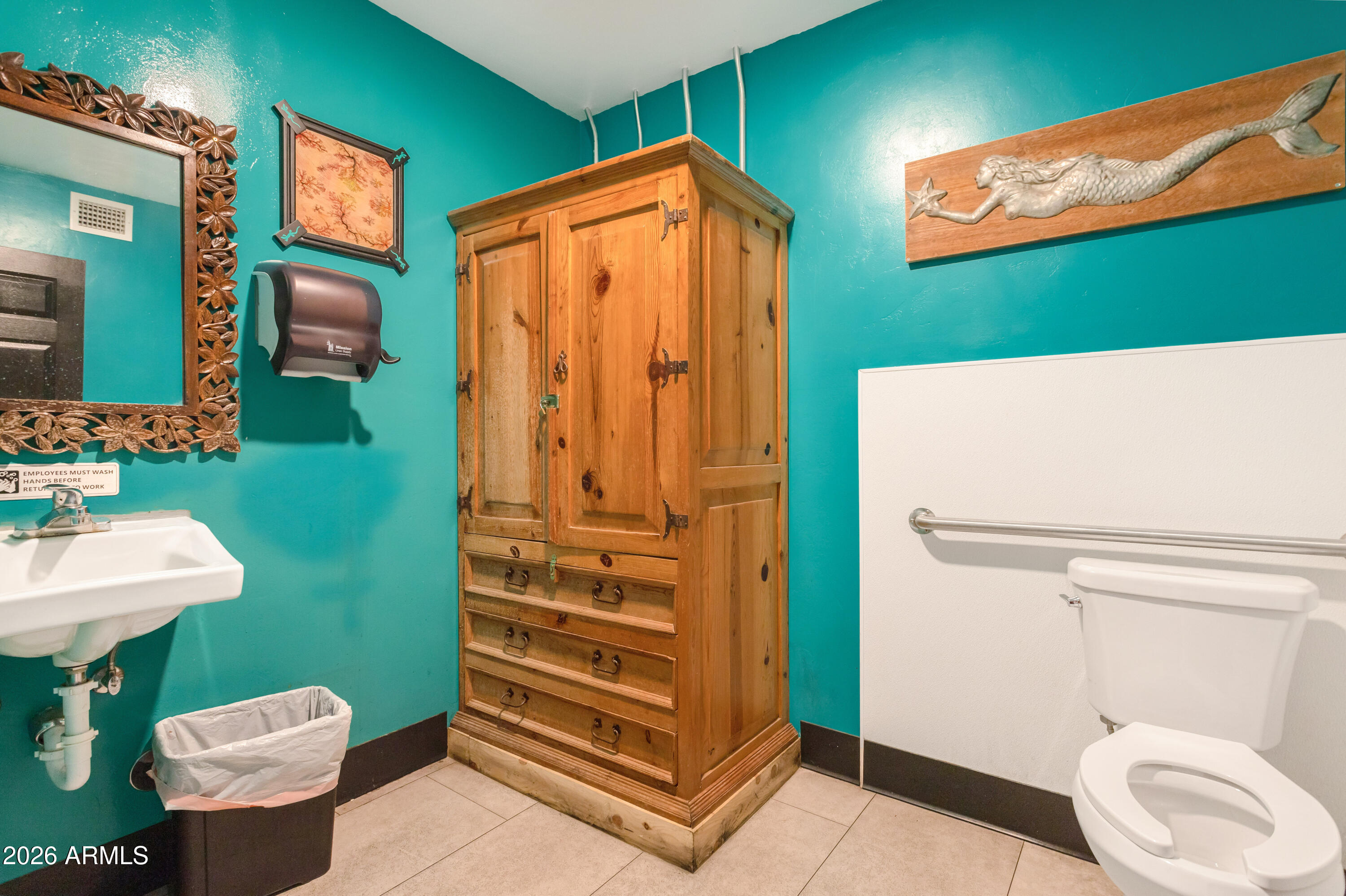 72-78 Main Street Bisbee, AZ 85603 - Photo 42 of 46 a bathroom with a sink a toilet and mirror