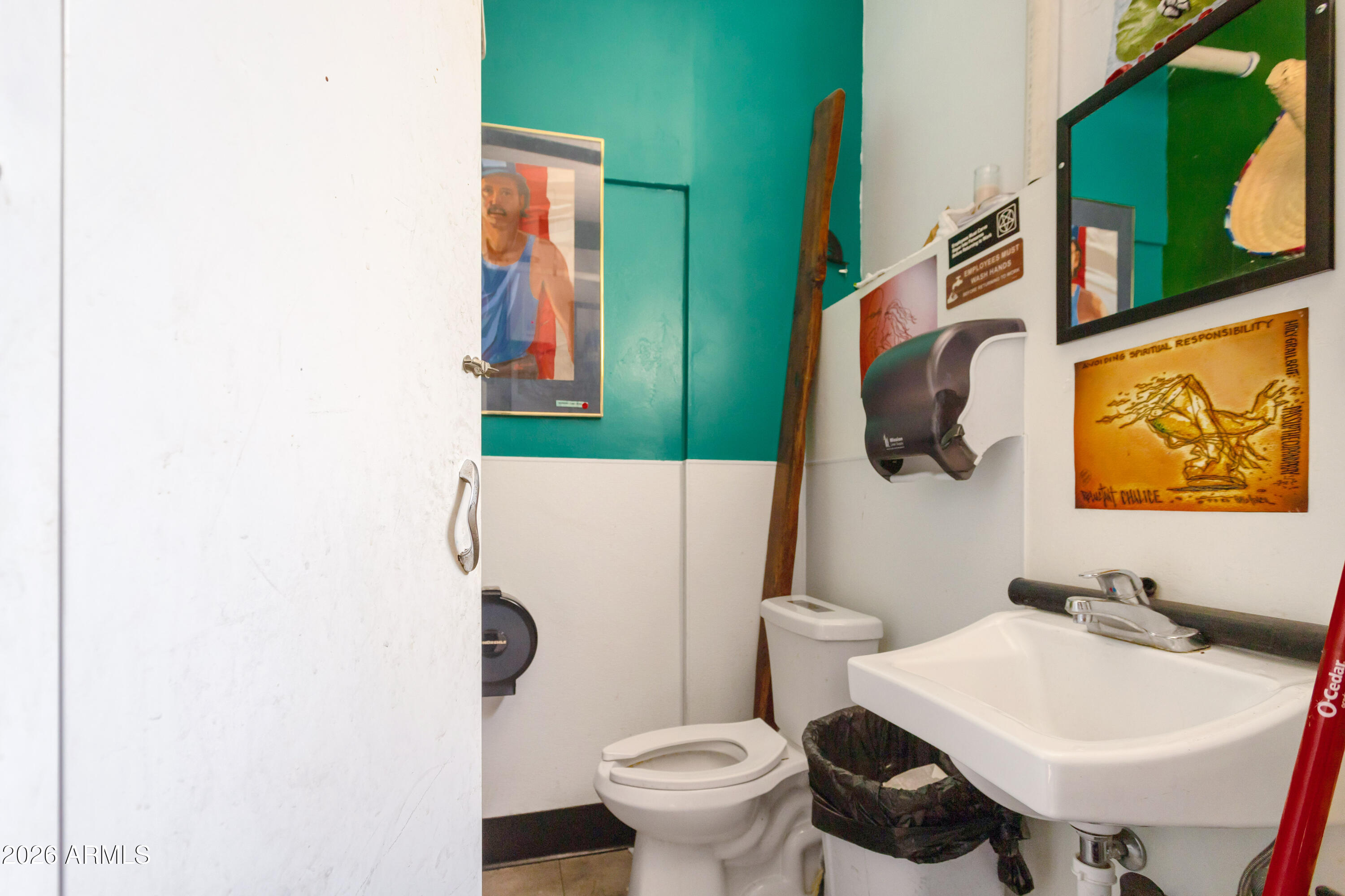 72-78 Main Street Bisbee, AZ 85603 - Photo 43 of 46 a bathroom with a toilet sink and mirror