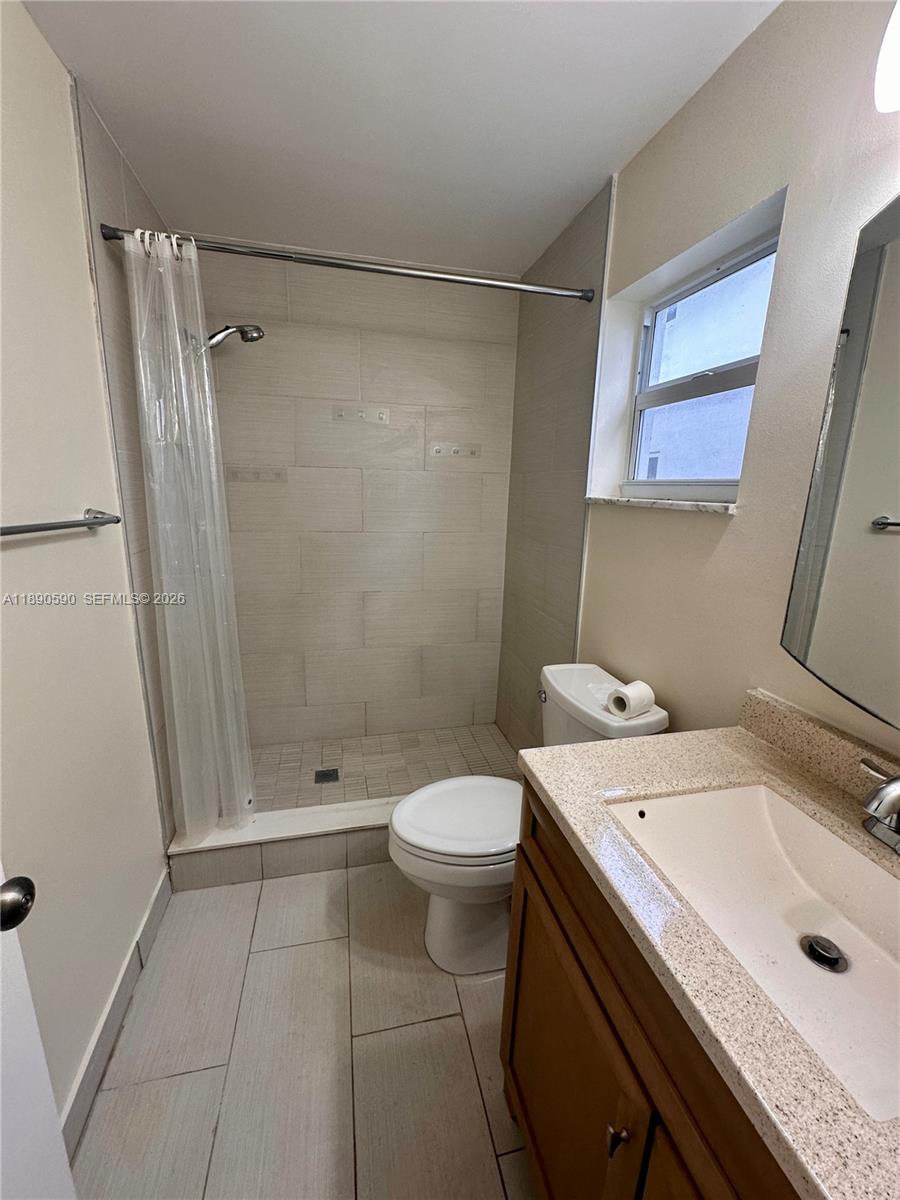1824 Monroe Street, Unit 4 Hollywood, FL 33020 - Photo 17 of 28 a bathroom with a sink a toilet and shower