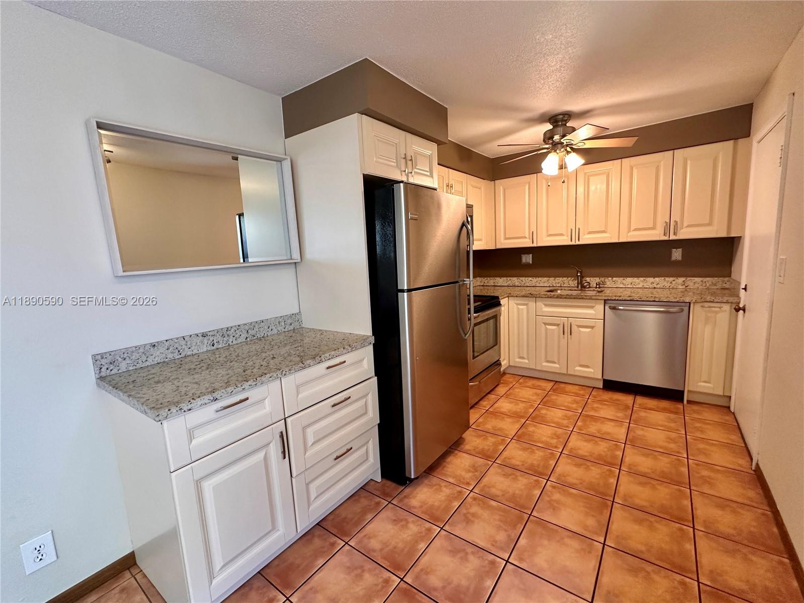 1824 Monroe Street, Unit 4 Hollywood, FL 33020 - Photo 6 of 28 a kitchen with stainless steel appliances granite countertop a refrigerator sink and microwave