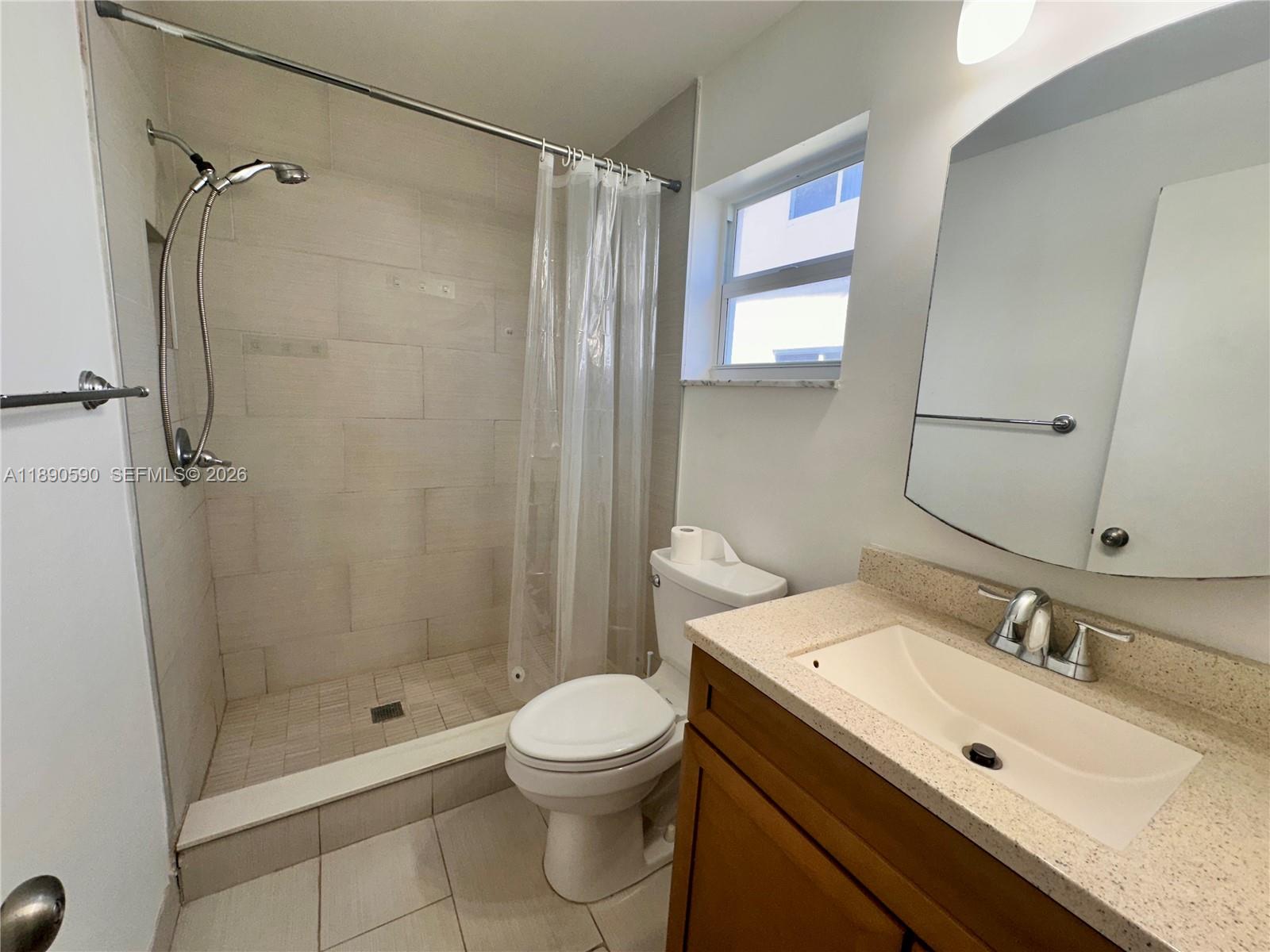 1824 Monroe Street, Unit 4 Hollywood, FL 33020 - Photo 7 of 28 a bathroom with a sink toilet and shower