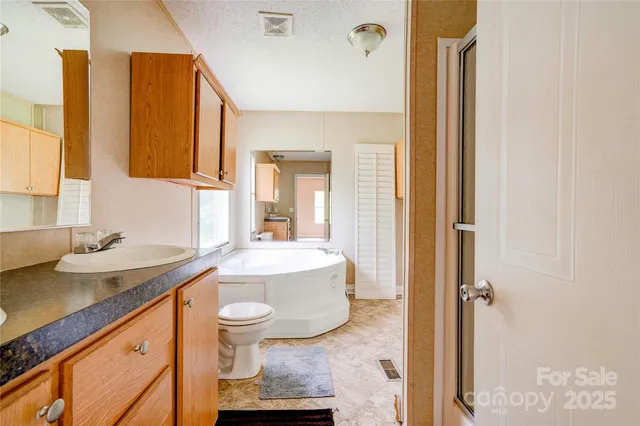 a bathroom with a tub and a large window