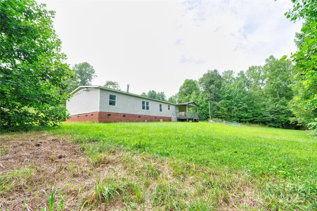a front view of house with yard and outdoor seating