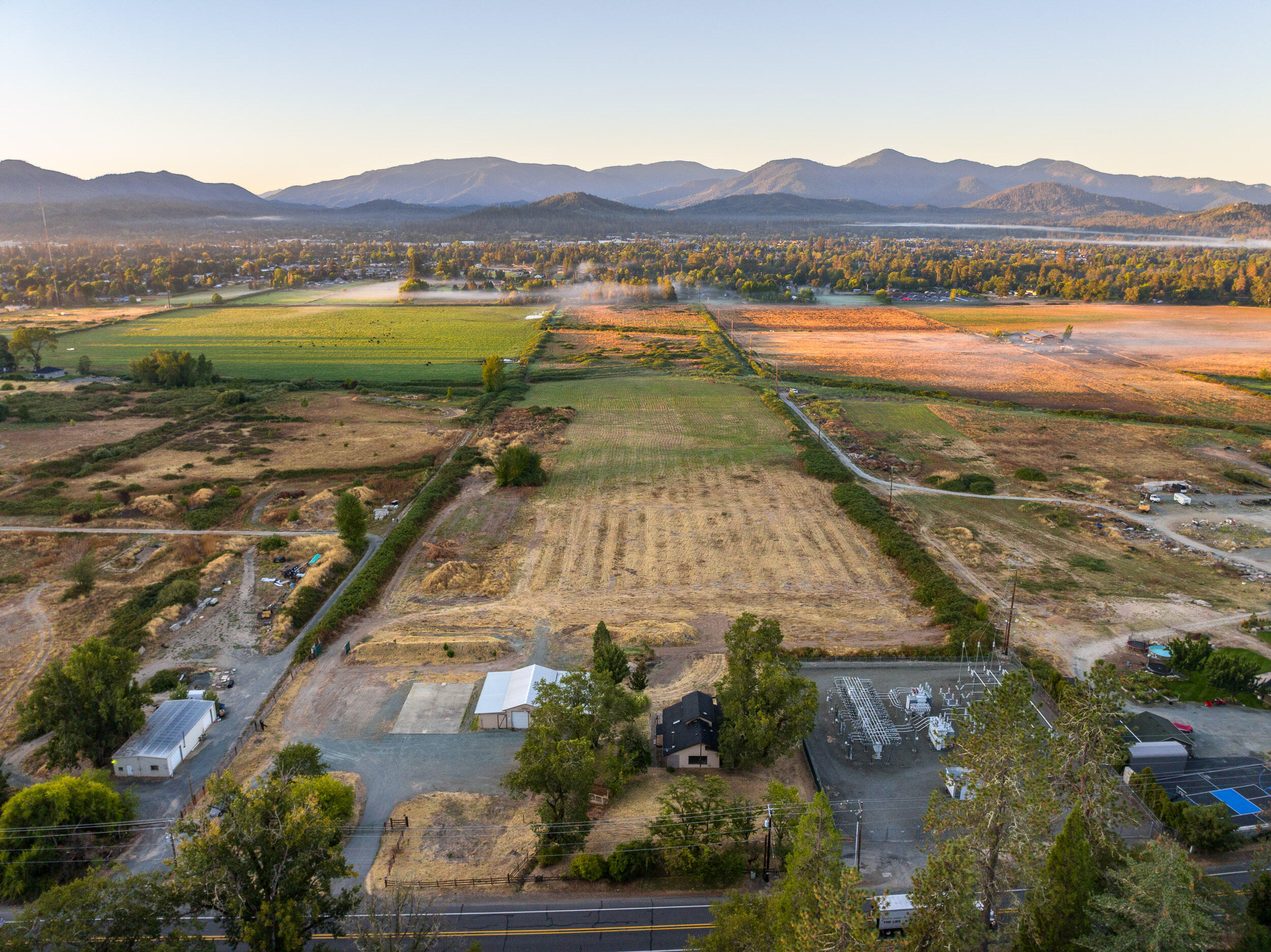 2781 Upper River Road Grants Pass, OR 97526 - Photo 2 of 53 a view of a lush green field with a yard