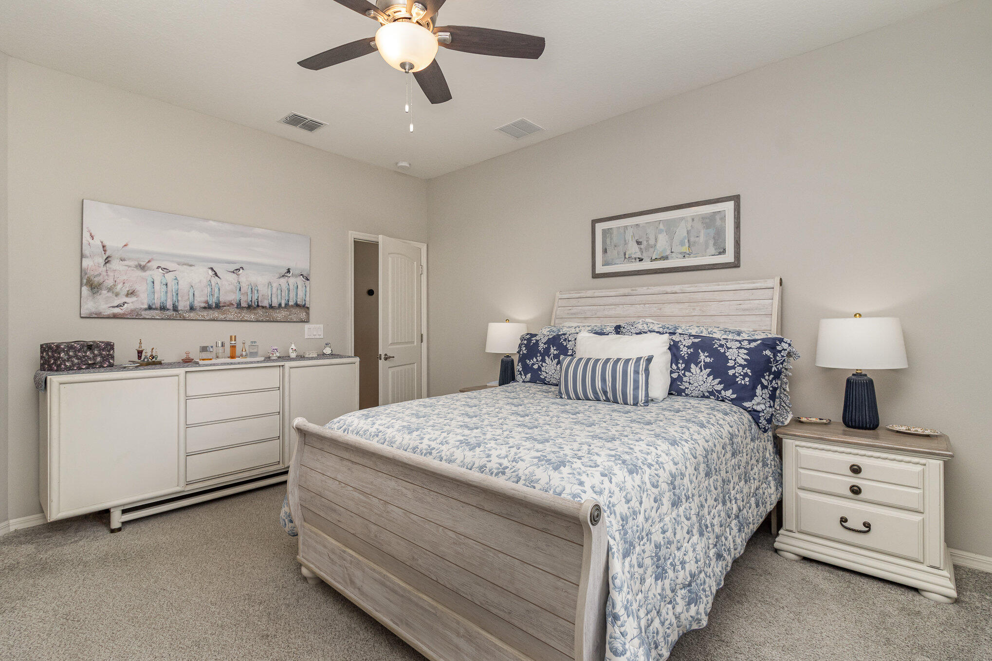 8512 Laguna Circle Micco, FL 32976 - Photo 14 of 24 a bedroom with a bed and a chandelier