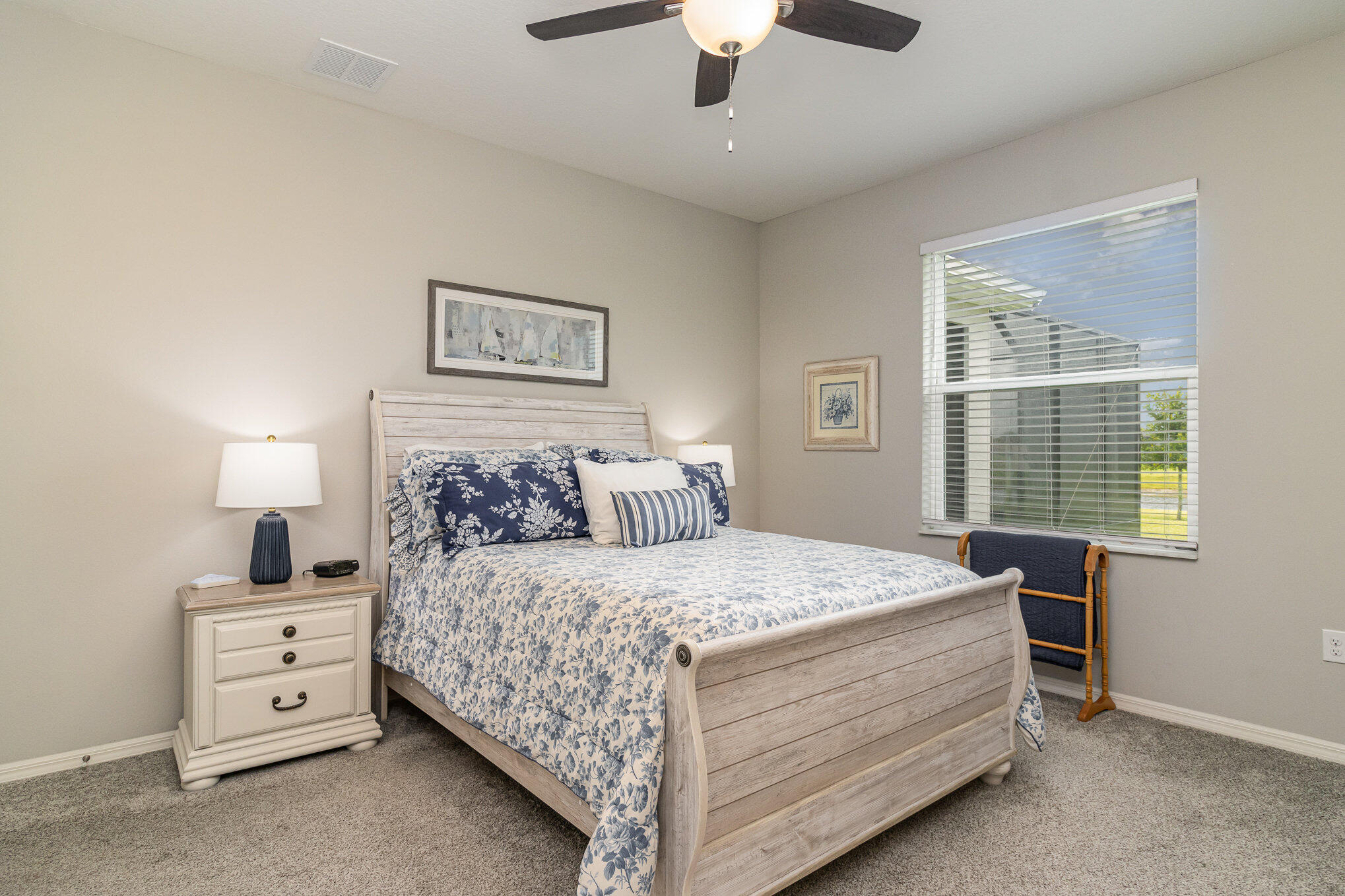 8512 Laguna Circle Micco, FL 32976 - Photo 15 of 24 a bedroom with a bed and a night stand