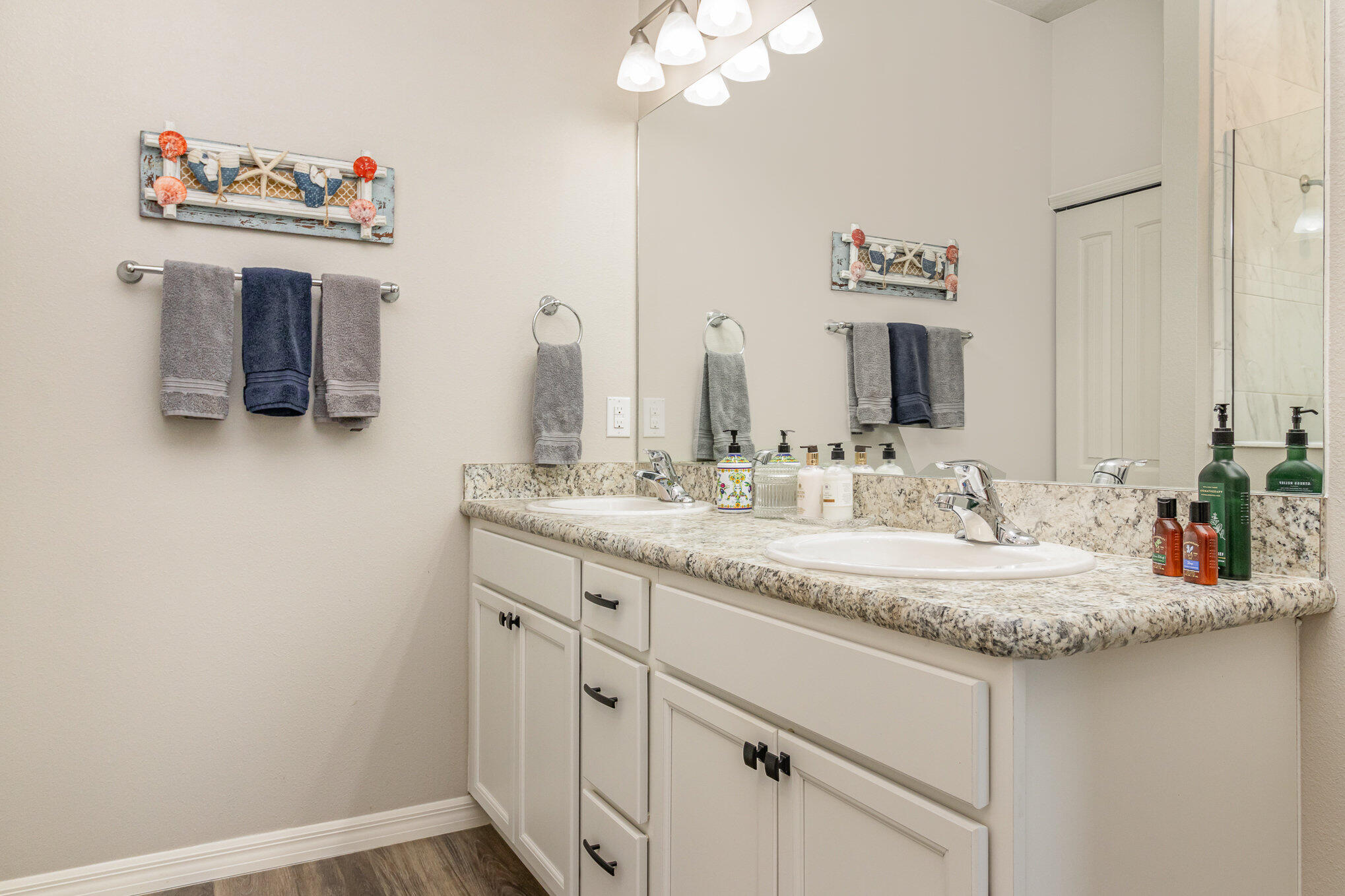 8512 Laguna Circle Micco, FL 32976 - Photo 16 of 24 a bathroom with a sink vanity and a mirror