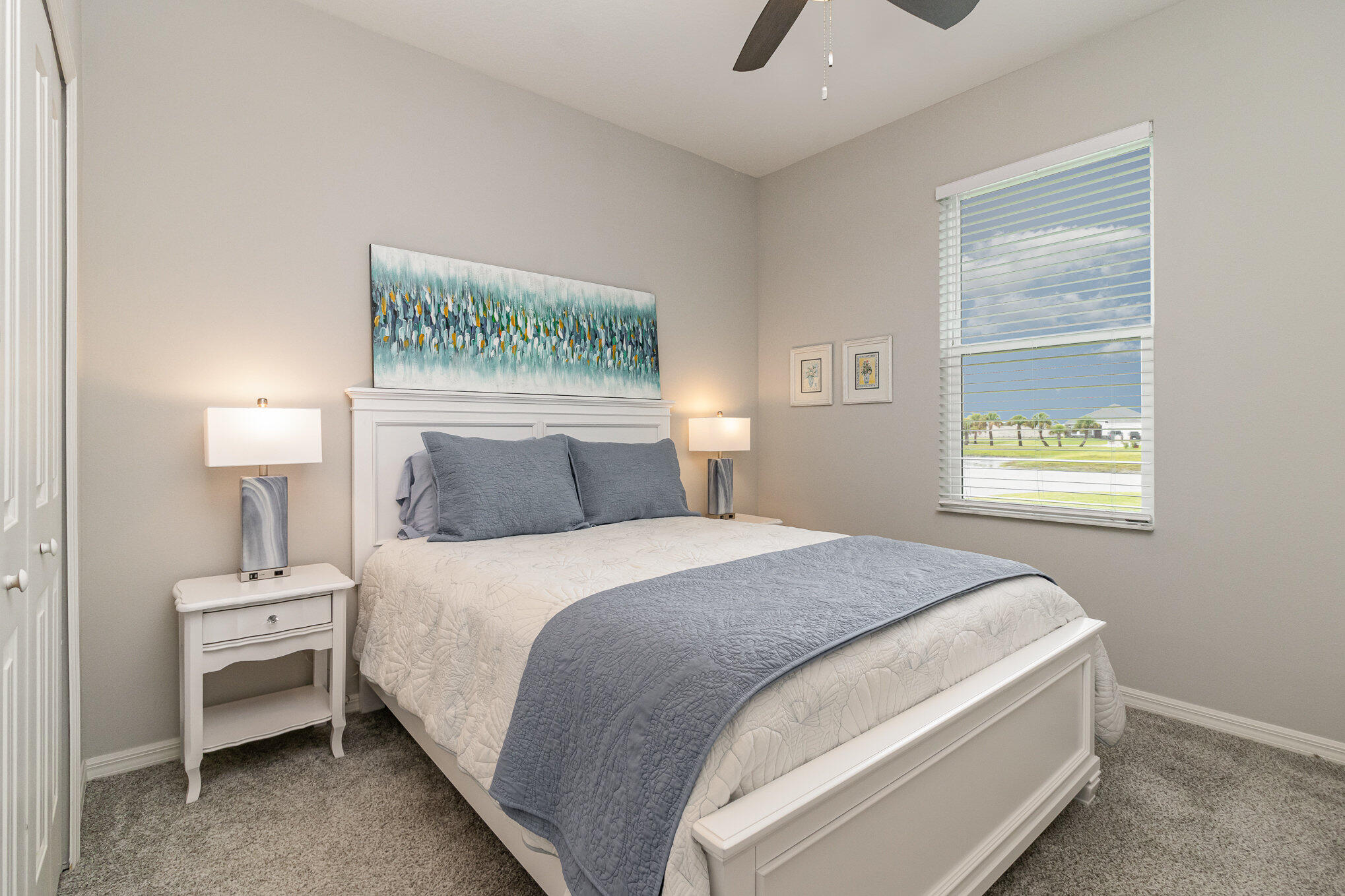 8512 Laguna Circle Micco, FL 32976 - Photo 18 of 24 a bedroom with a bed and a lamp