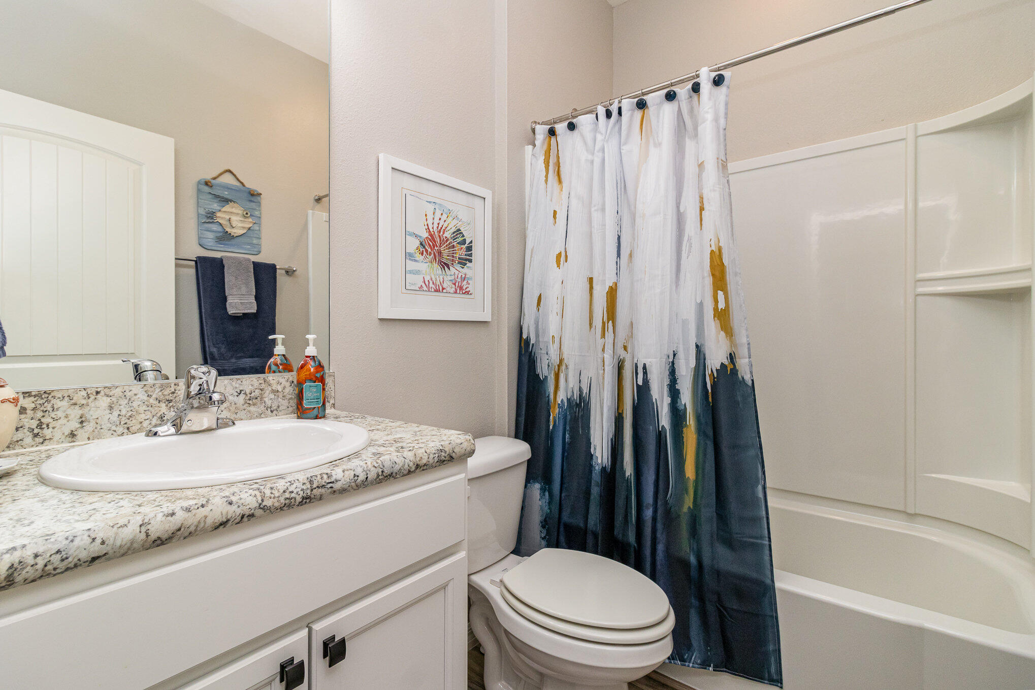 8512 Laguna Circle Micco, FL 32976 - Photo 19 of 24 a bathroom with a granite countertop sink toilet and shower