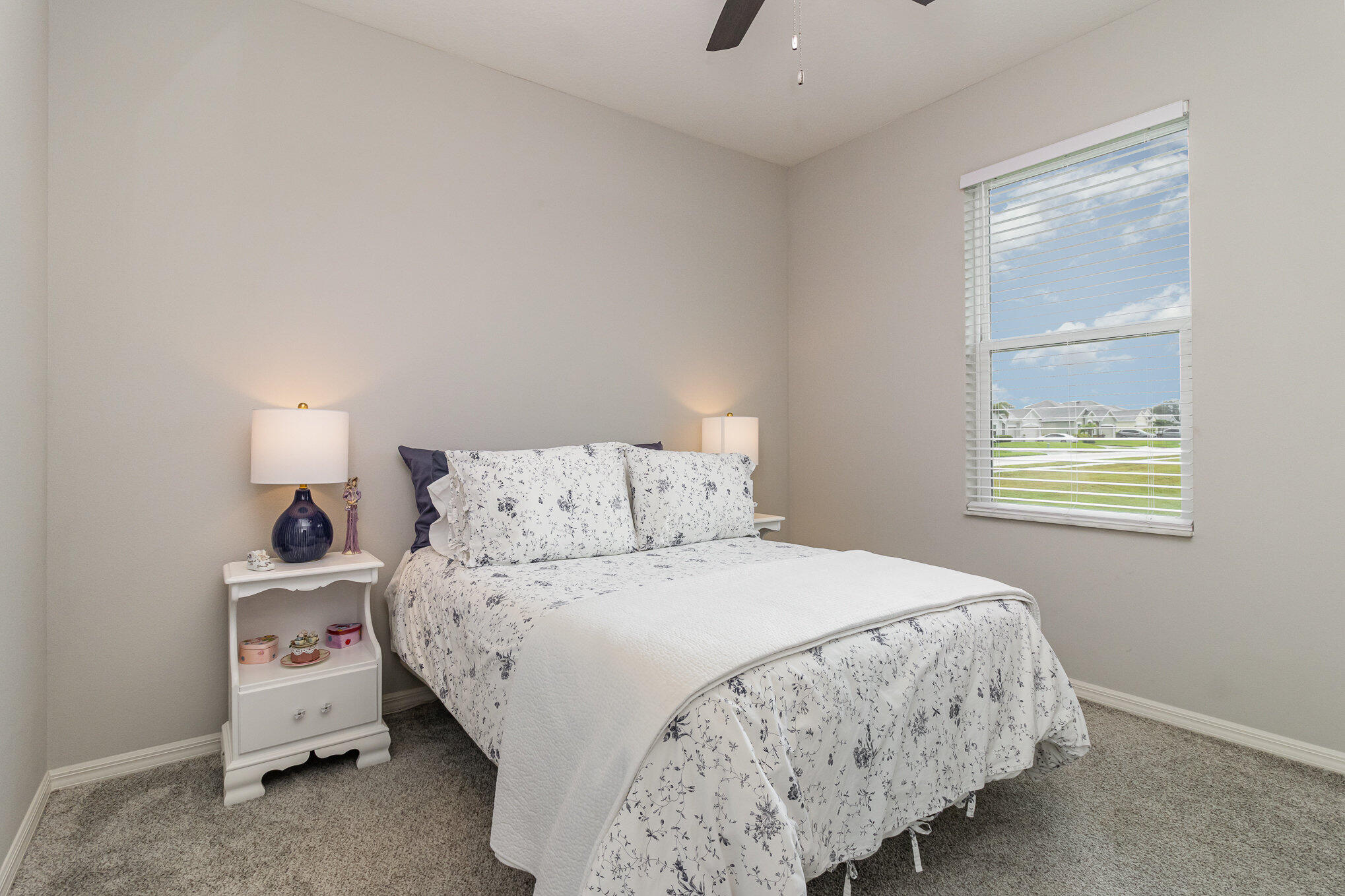 8512 Laguna Circle Micco, FL 32976 - Photo 20 of 24 a bedroom with a bed and a window