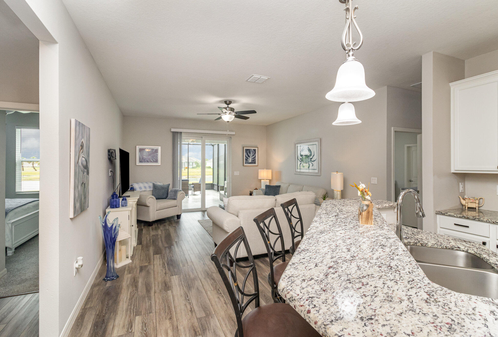 8512 Laguna Circle Micco, FL 32976 - Photo 5 of 24 a large bedroom with furniture and a wooden floor